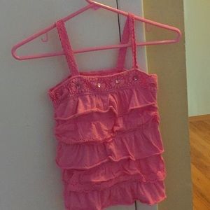 A pink, ruffled tank top.